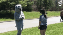 a mascot in a dog costume is talking to a woman