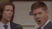 two men are standing next to each other with their mouths open and screaming .