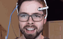 a man with glasses and a headset on his forehead