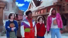 a group of people are standing next to each other on a city street .