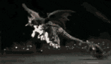 a black and white image of a dragon flying through the air .