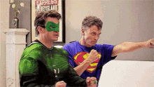two men in superhero costumes are standing next to each other in front of a sign that says express dublin .