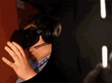 a man wearing headphones and a virtual reality headset with the word oculus on it