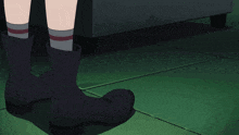 a person wearing black boots standing next to a white ball