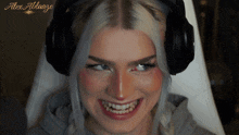 a woman wearing headphones with alex ablaage written on the bottom