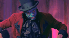 a man with blue paint on his face is standing next to a woman