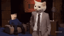 a man in a suit and tie with a cat head stands in front of a microphone