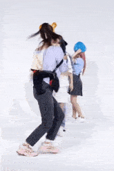 a group of young women are dancing together in a room .