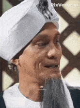 a man with a beard and a white turban on his head