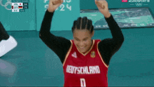 a basketball player wearing a red jersey that says deutschland on it