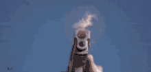 a close up of a person holding a gun with smoke coming out of the barrel .