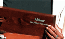 a person is holding a kicker torjagerkanone box