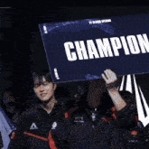 a person holding a sign that says champion