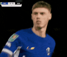 a soccer player in a blue shirt with the word new on the bottom right