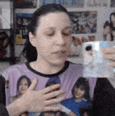 a woman is wearing a purple shirt with a picture of a girl on it