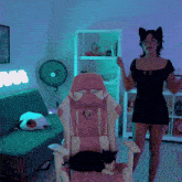 a woman in a cat costume is standing in front of a pink chair that says xtreme 2