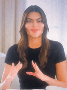 a woman in a black t-shirt with a fake face on her face .