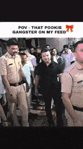 a man in a black shirt is standing in front of a crowd of police officers .