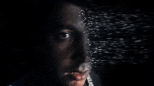 a close up of a man 's face with a blurry background behind him