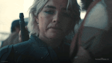 a close up of a woman 's face with thunderbolts on the bottom