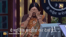a woman covering her eyes in front of a sony logo