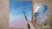 a person is painting a blue and pink sky with the words made in animotica below them