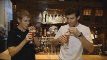 Sebastian Vettel Drinking Mark Webber Drinking GIF - Sebastian Vettel Drinking Mark Webber Drinking Webber Vettel Drinking GIFs