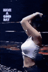 a woman is stretching her arms in front of a sign that says have a good day .