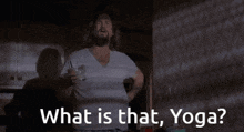 a man is holding a glass in his hand and says what is that yoga