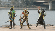 three superheros are standing next to each other in front of a river