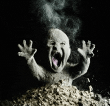 a black and white photo of a ghost with its mouth open coming out of the ground .