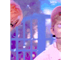 a close up of a person wearing a pink hat and headphones on a stage .