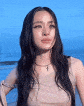 a woman with long hair and a cross necklace
