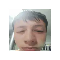 a close up of a person 's face with their eyes closed and their mouth open .