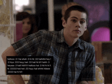 a young man in a plaid shirt is looking at the camera