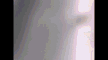 a close up of a gray and pink background with a blurred image of a person 's face .