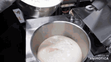 a stainless steel bowl filled with dough and the words made in animatica on the bottom