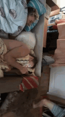 a woman is laying on a bed with a pillow that has sea shells on it