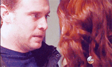 a man and a woman are looking into each other 's eyes with abc written on the bottom of the screen