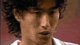 a close up of a man 's face with a blurred background