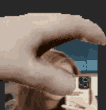 a pixel art of a person taking a selfie