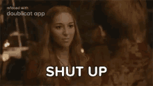 a man and a woman are standing next to each other and the woman is telling the man to shut up .