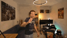 a man dancing in a room with a dark souls poster on the wall behind him
