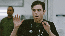 a man with a stethoscope around his neck is making a funny face
