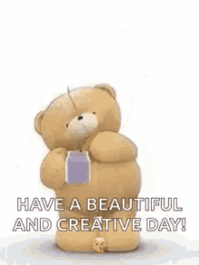 a teddy bear is standing in front of a blue heart and holding a box .