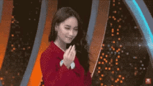 a pixelated image of a woman in a red jacket