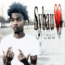 a young man giving the middle finger in front of a sybau heart