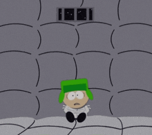 a cartoon character with a green hat is in a cell