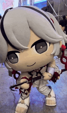 a stuffed doll with a sword and a red rose in her hand