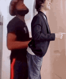 a man in a suit and tie is pointing at his shadow